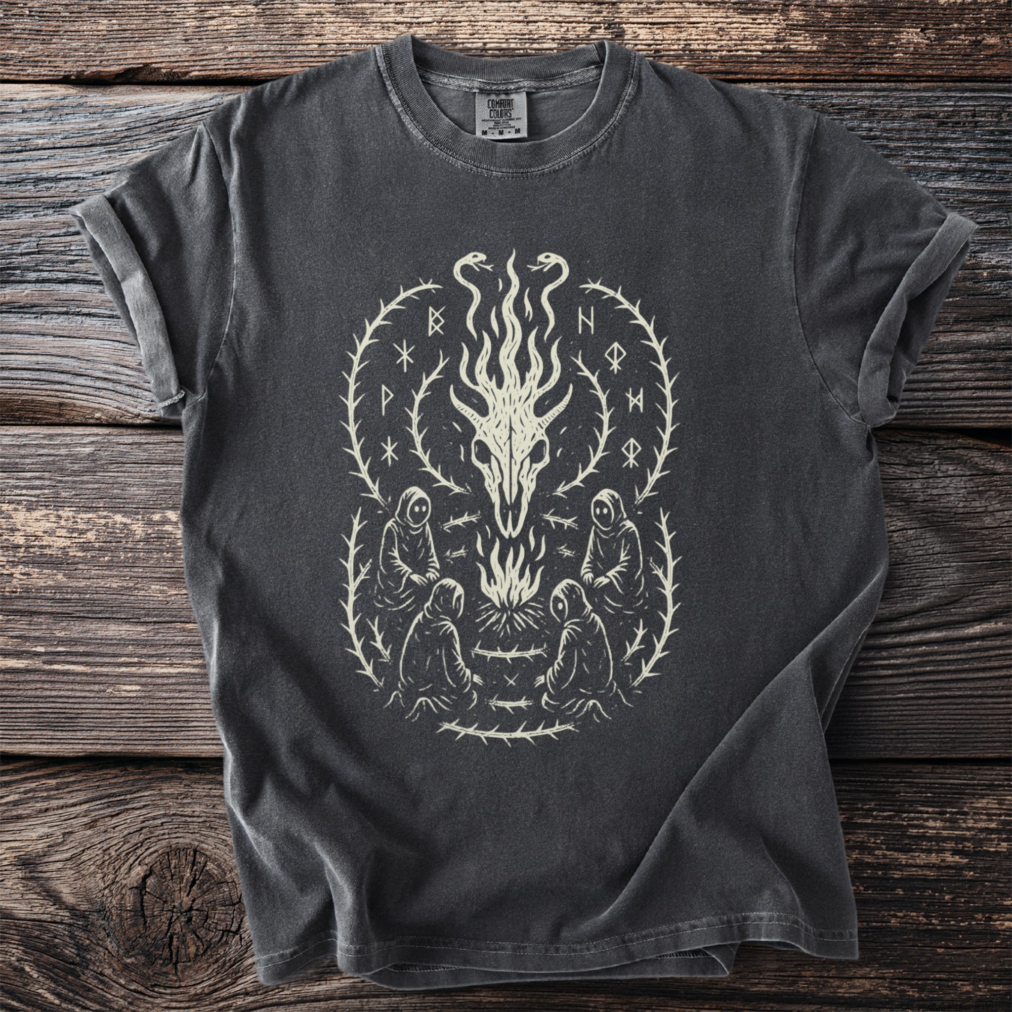 Dark grey t-shirt featuring a light cream circular design with a skeletal dragon head and surrounding figures.