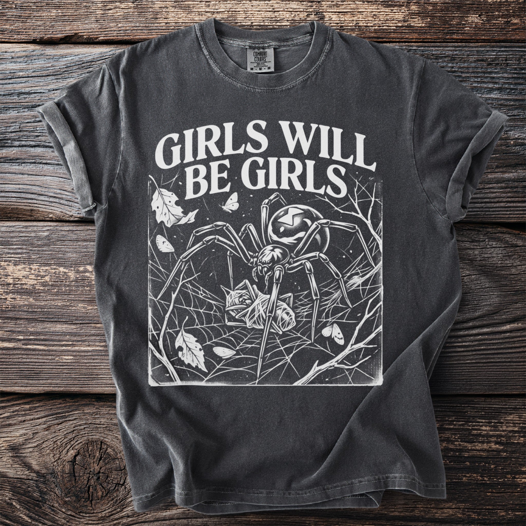 Dark t-shirt with white text "GIRLS WILL BE GIRLS" and spider graphic.