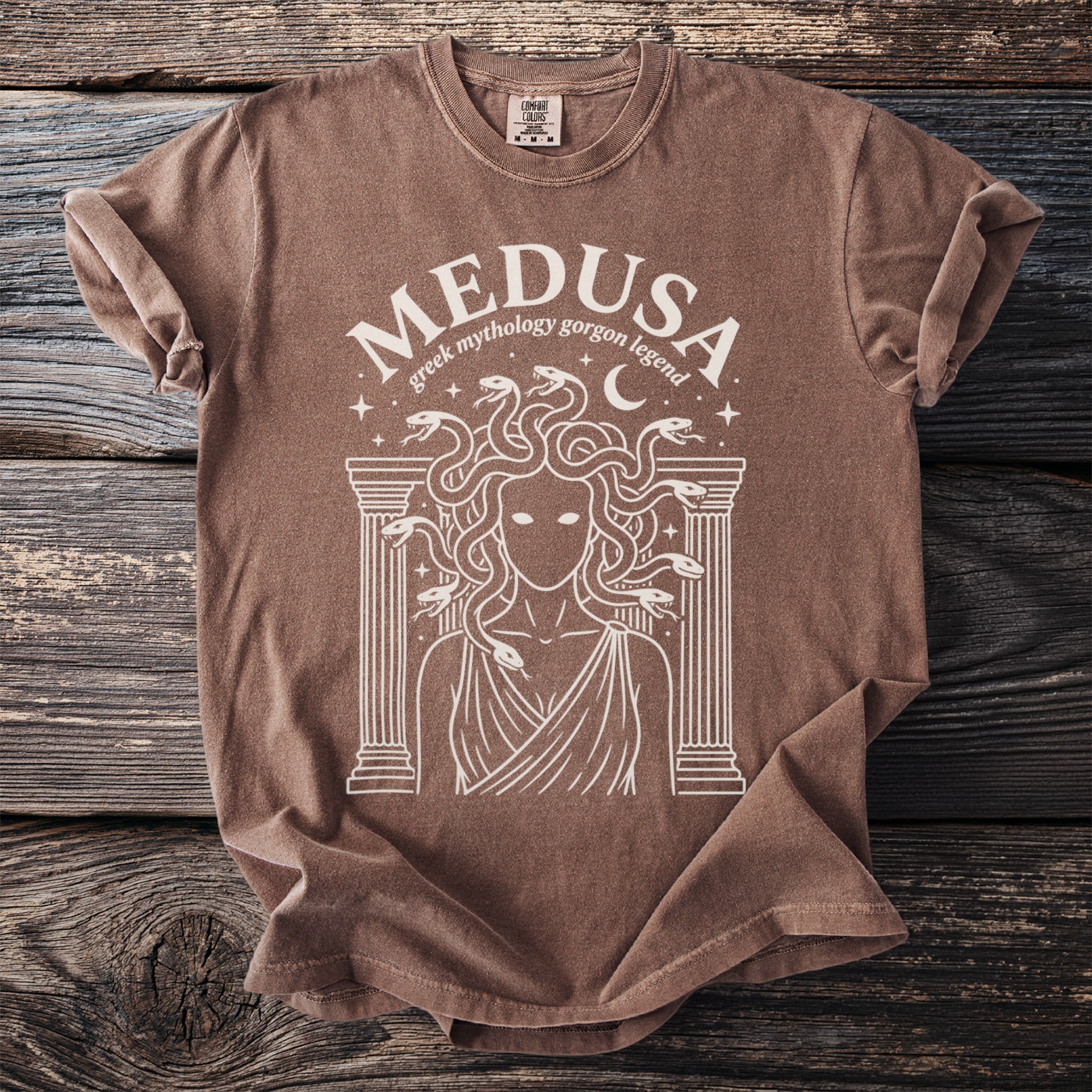 Brown t-shirt with white Medusa greek mythology gorgon legend graphic.