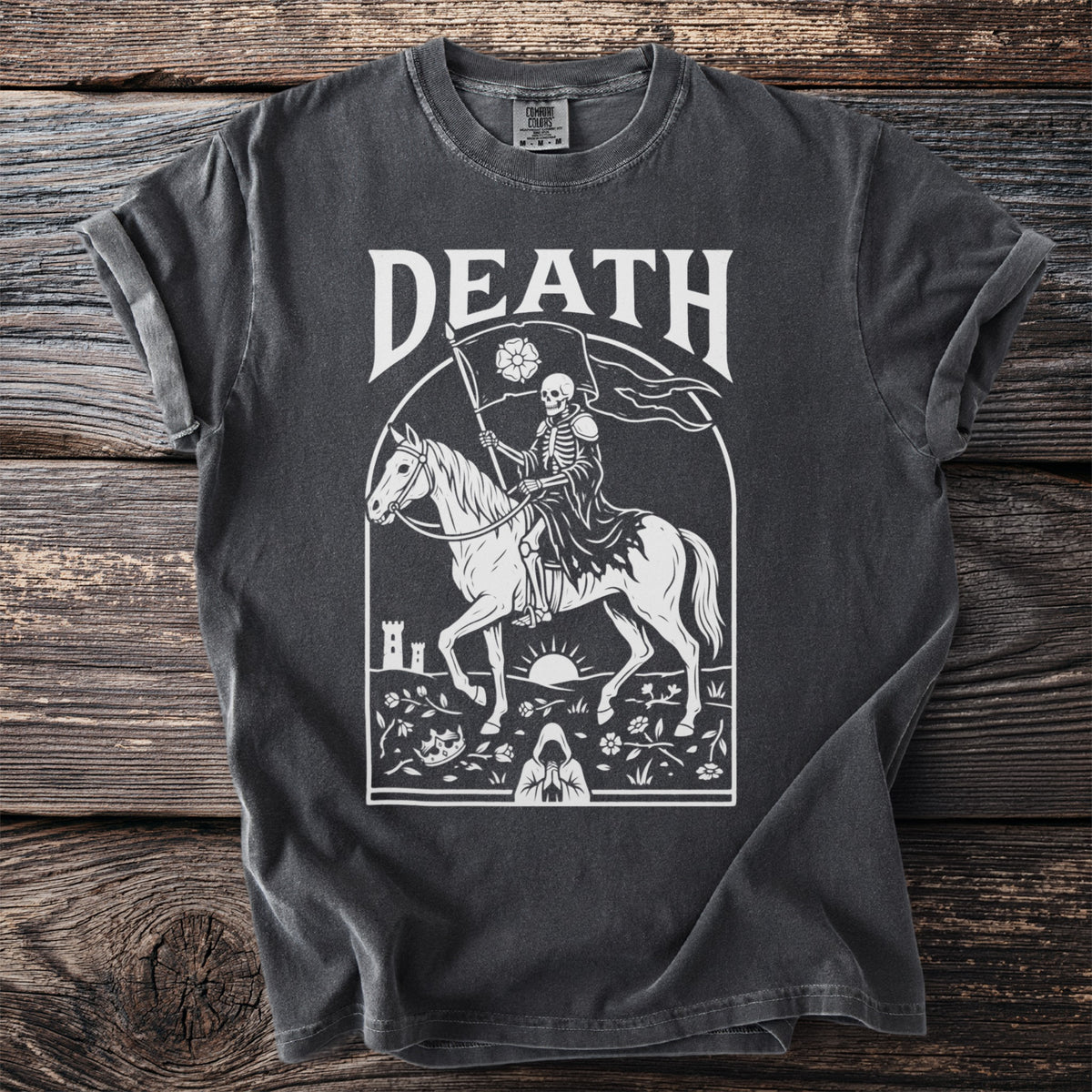 T-shirt with white graphic of a skeleton riding a horse, holding a flag with a rose.
