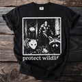 Black t-shirt with a graphic of Bigfoot, opossum, raccoon, moth, and frog. Text says "protect wildlif".