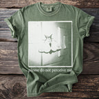 Green t-shirt with moth graphic and text "please do not perceive me".