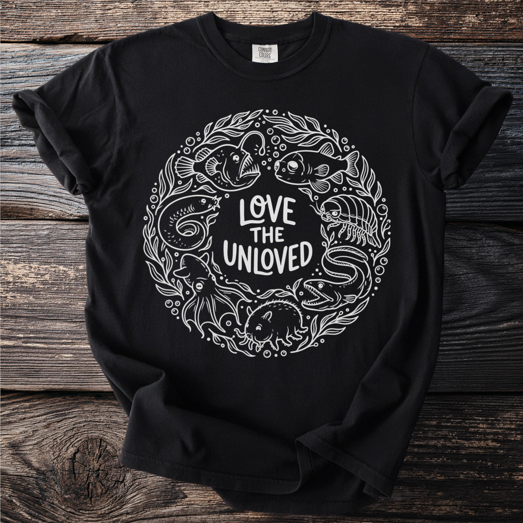Black t-shirt with a white circular design featuring various sea creatures and the text "LOVE THE UNLOVED."
