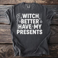 Dark t-shirt with white text "Witch Better Have My Presents" and Halloween graphics.