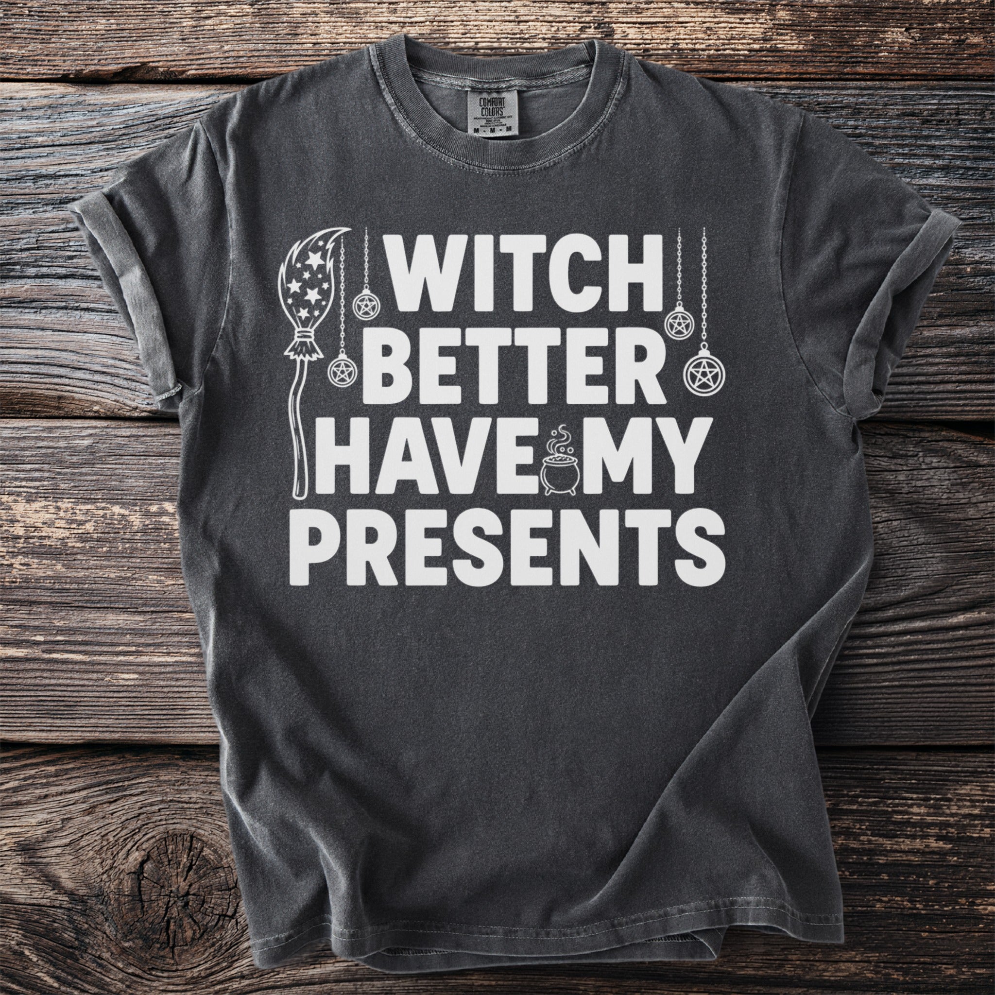 Dark t-shirt with white text "Witch Better Have My Presents" and Halloween graphics.