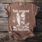 Brown t-shirt with graphic of a possum holding a large trout, text "fish around and find trout".