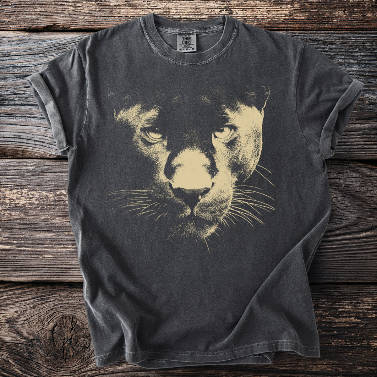 Dark grey t-shirt with a beige panther portrait graphic and Comfort Colors tag.