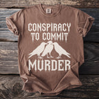 Brown t-shirt with white text and three ravens: "Conspiracy to Commit Murder".