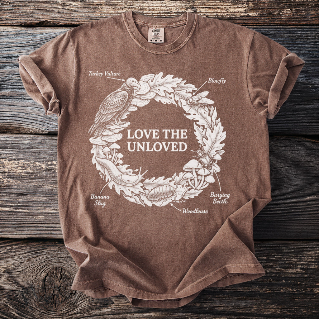 Brown t-shirt with "Love the Unloved" text surrounded by insects and animals.