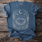 Blue t-shirt with a mystical forest scene featuring a moon, moths, mushrooms, and fairies.