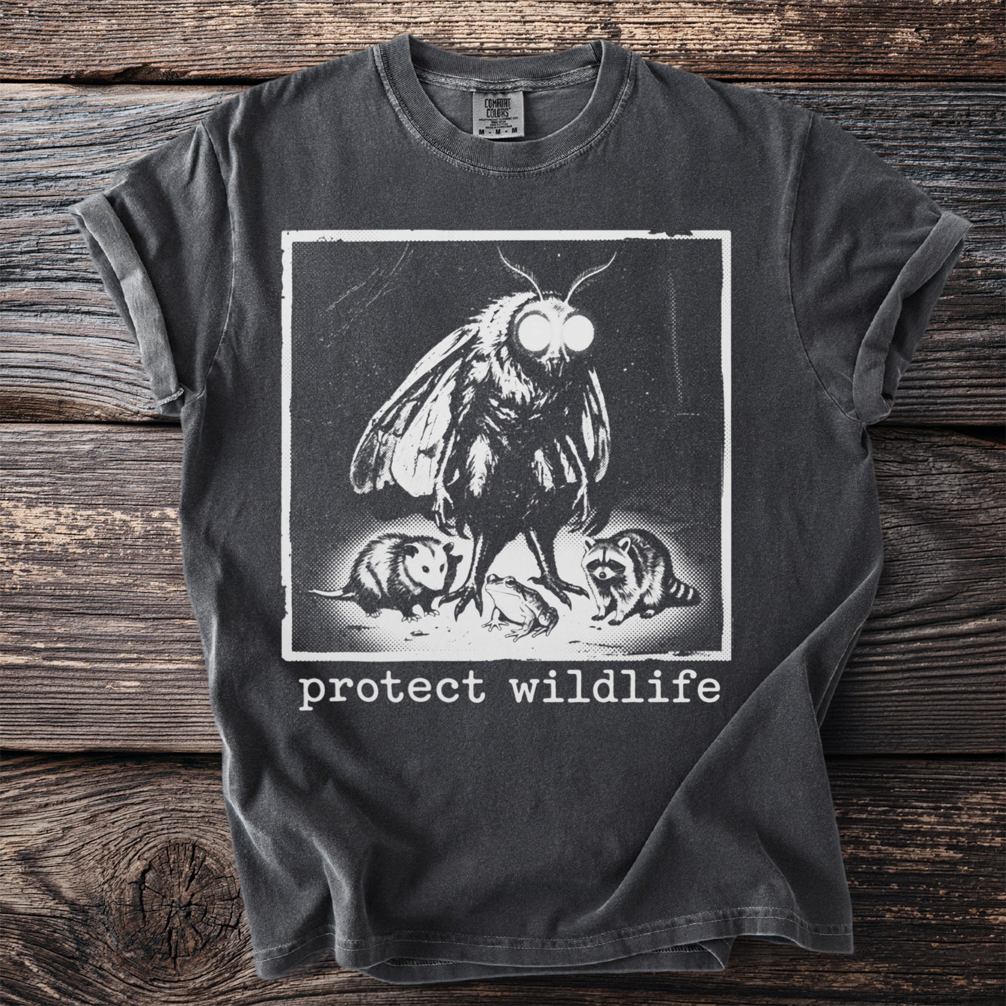 Vintage style t-shirt with moth, opossum, frog, raccoon graphic and "protect wildlife" text.