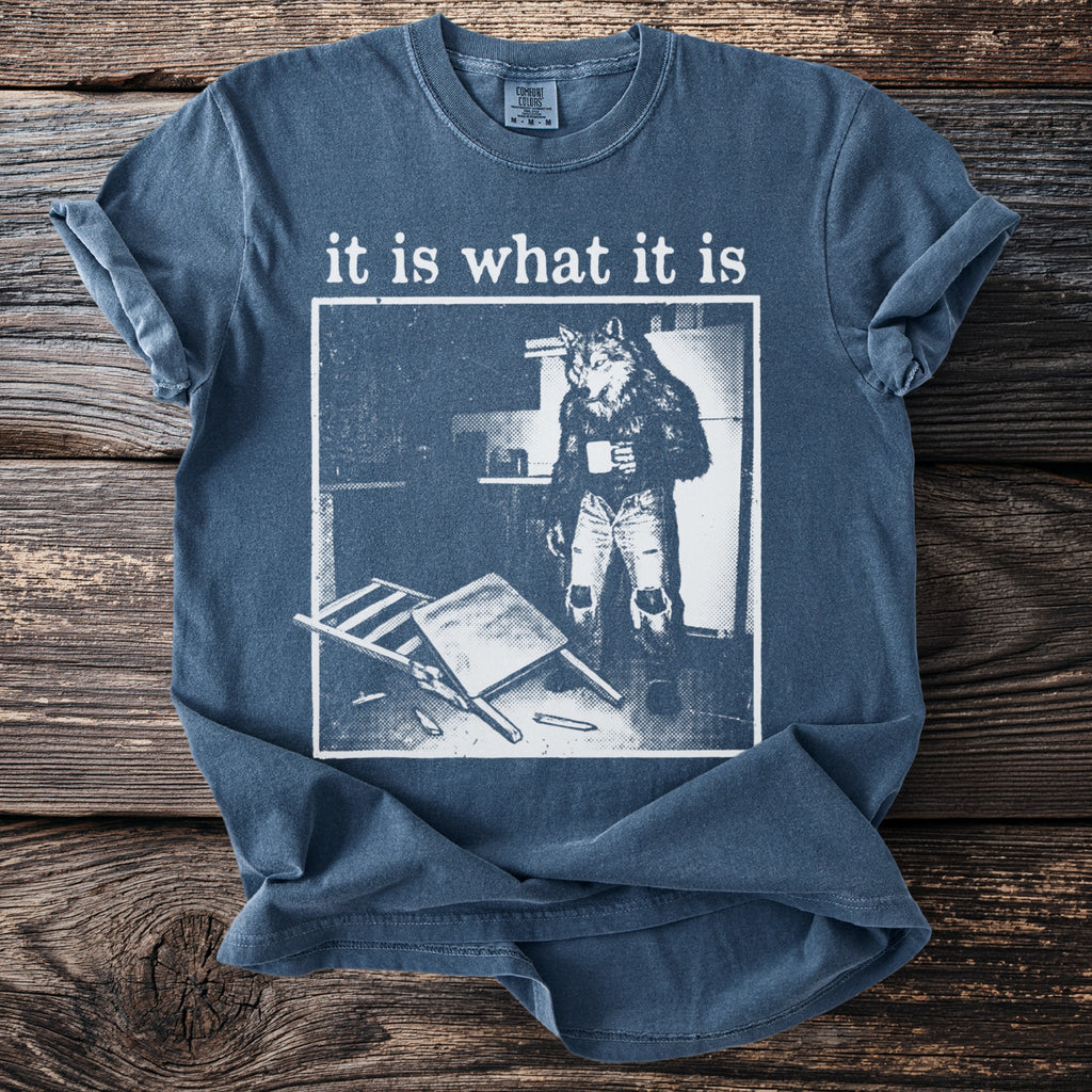 T-shirt with a werewolf holding a coffee mug and the text "it is what it is."