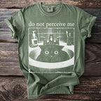 Green t-shirt with "do not perceive me" and a startled cat in a sink graphic.