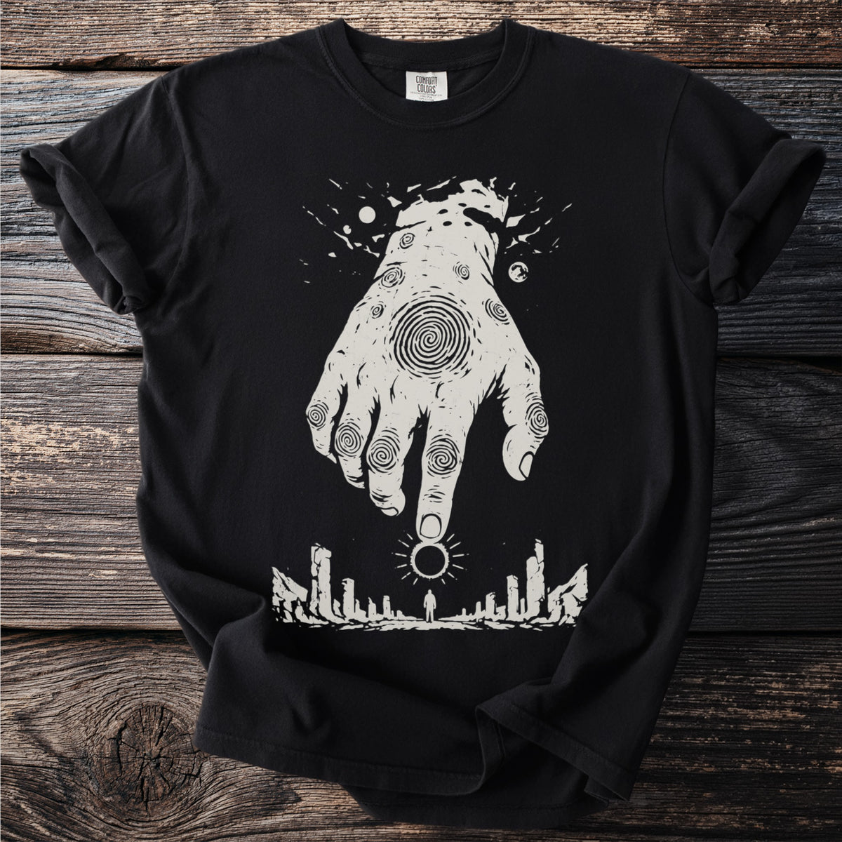 Black t-shirt with white graphic of a hand over a silhouette and a solar eclipse.