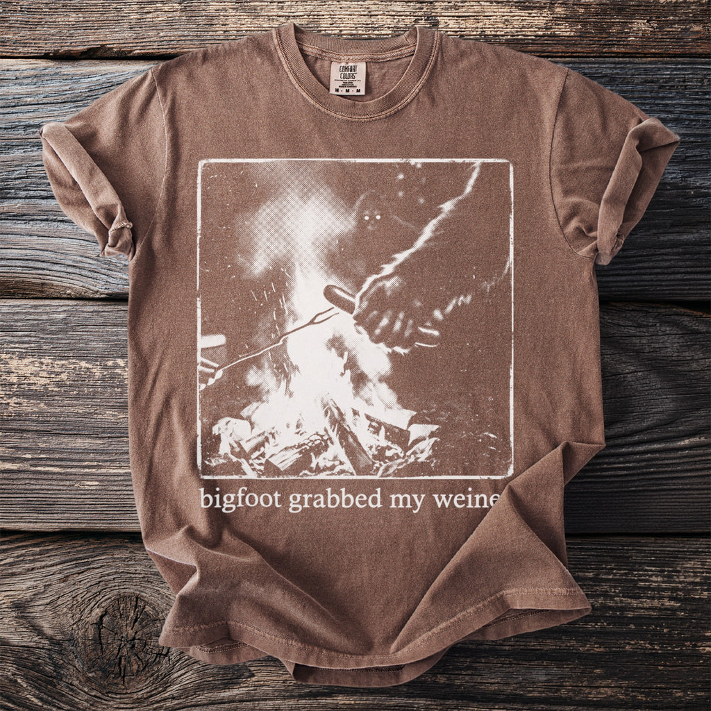 Brown t-shirt with bigfoot grabbed my weiner graphic and campfire image.
