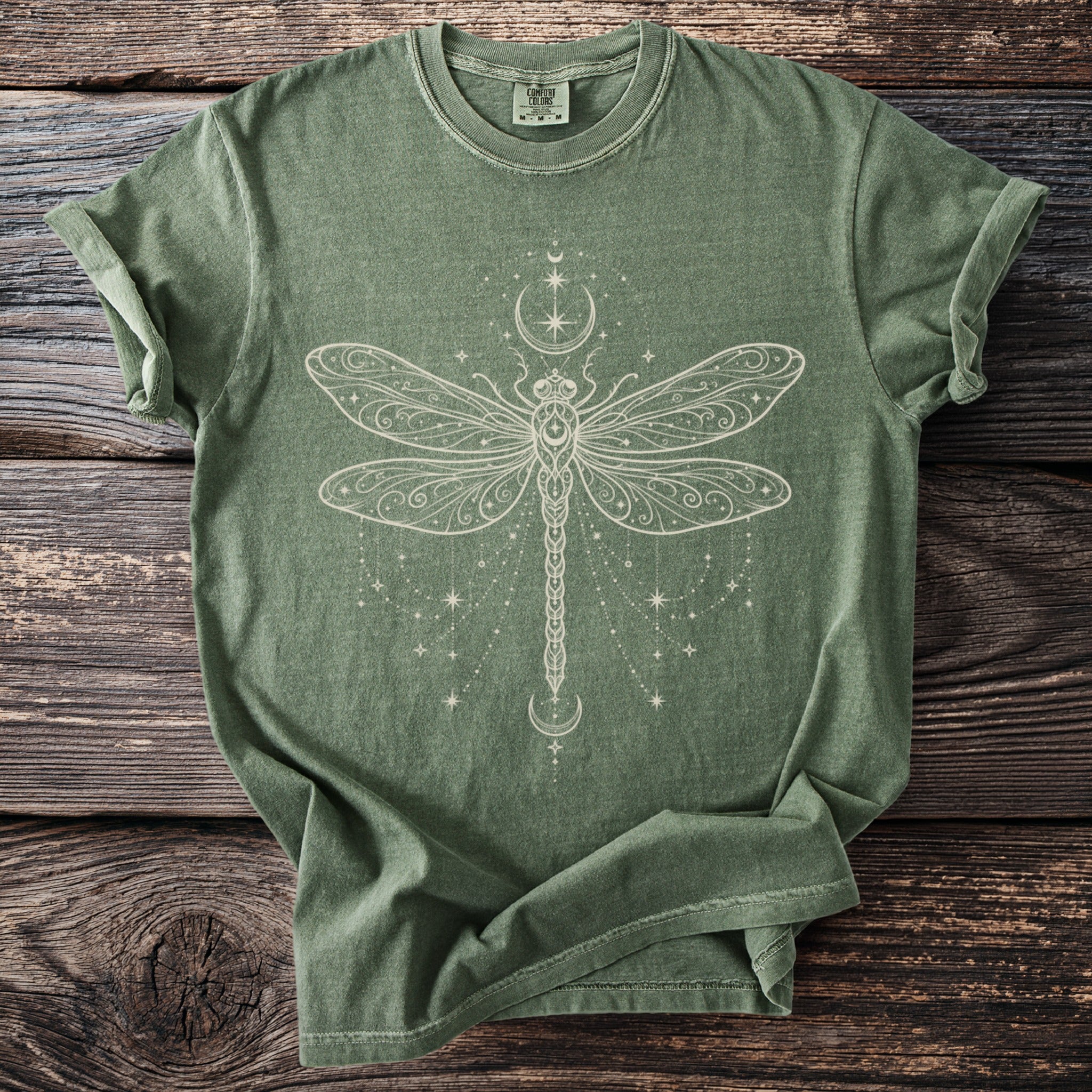 Green t-shirt with cream-colored dragonfly and celestial print.