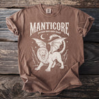 Manticore graphic tee with text "MANTICORE: persian man eater beast" on brown shirt.