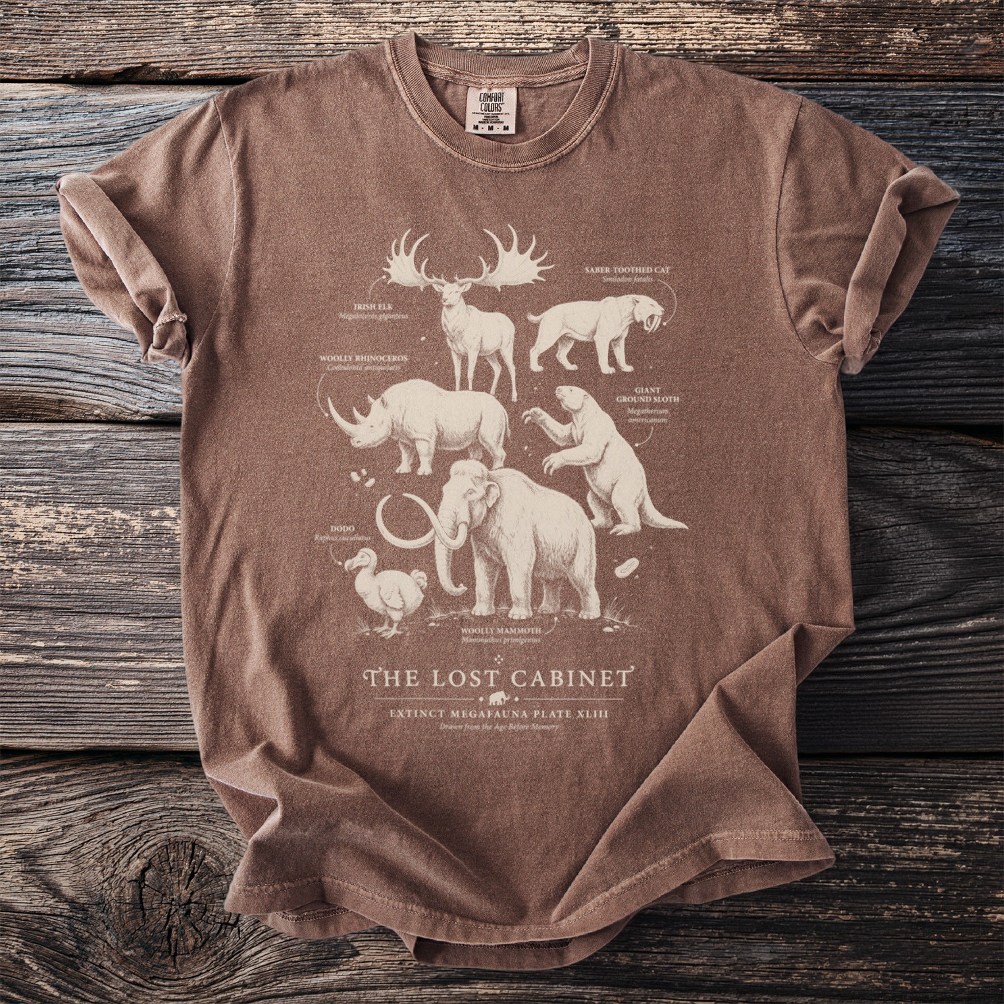 Brown t-shirt with extinct megafauna illustrations and "The Lost Cabinet" text.