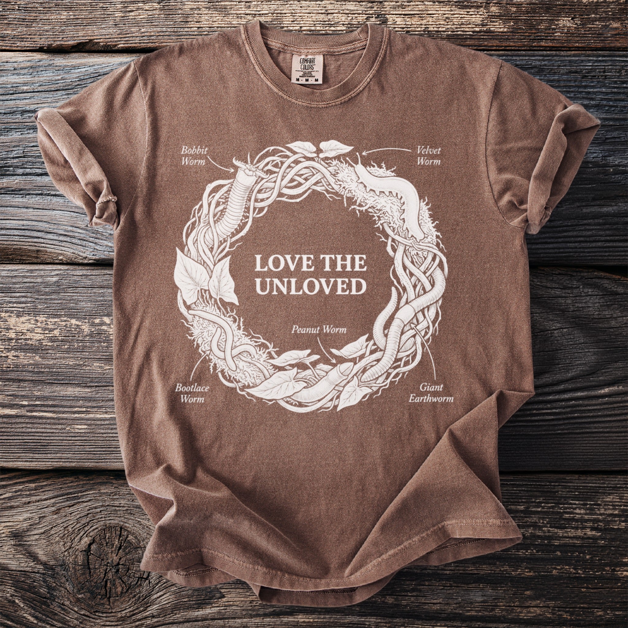 Brown t-shirt with "Love The Unloved" and illustrations of various worms.