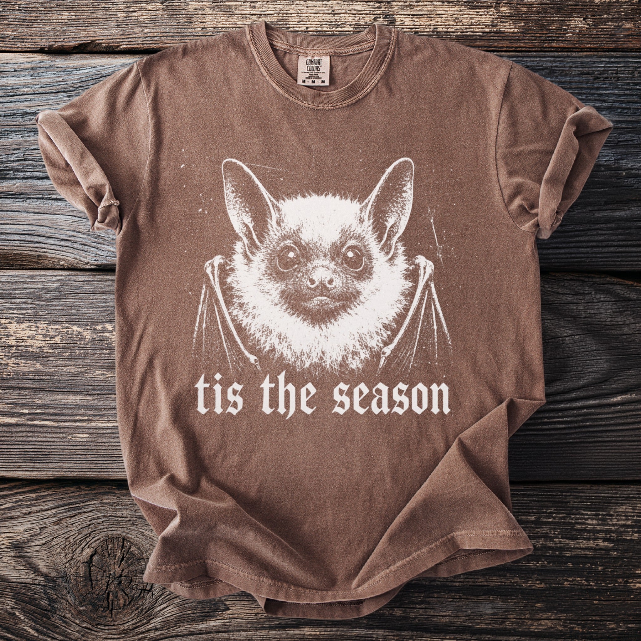 Brown t-shirt with a white bat graphic and "tis the season" text.