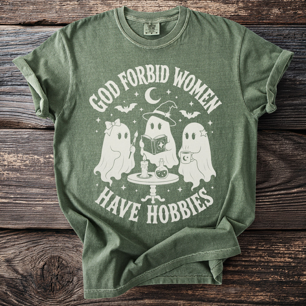 Green t-shirt featuring three ghosts with text "God forbid women have hobbies."