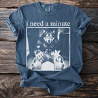T-shirt with a werewolf sitting with a cat and text "i need a minute".