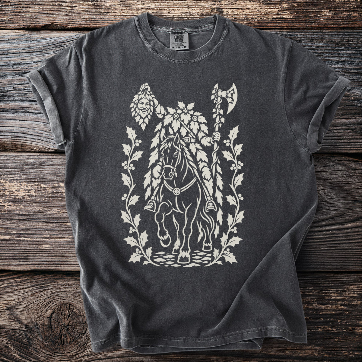 Dark t-shirt with white graphic of a figure on horseback holding an axe, surrounded by holly.