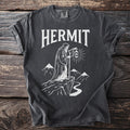 Gray t-shirt with "HERMIT" text and a robed figure holding a lantern.