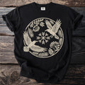 Black t-shirt with circular raven, snowflake, and berry branch design.