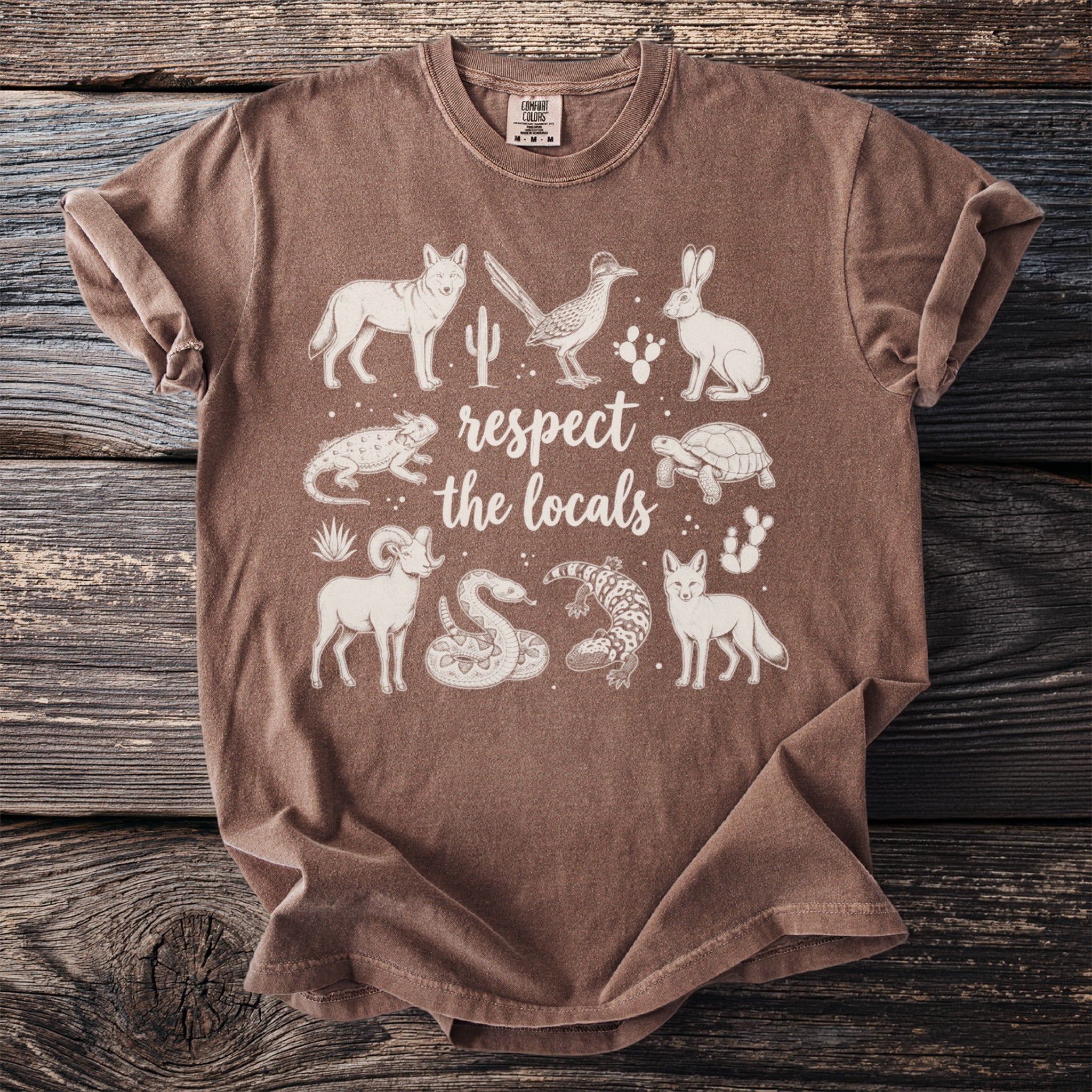 Brown t-shirt with white desert animals and "respect the locals" text.