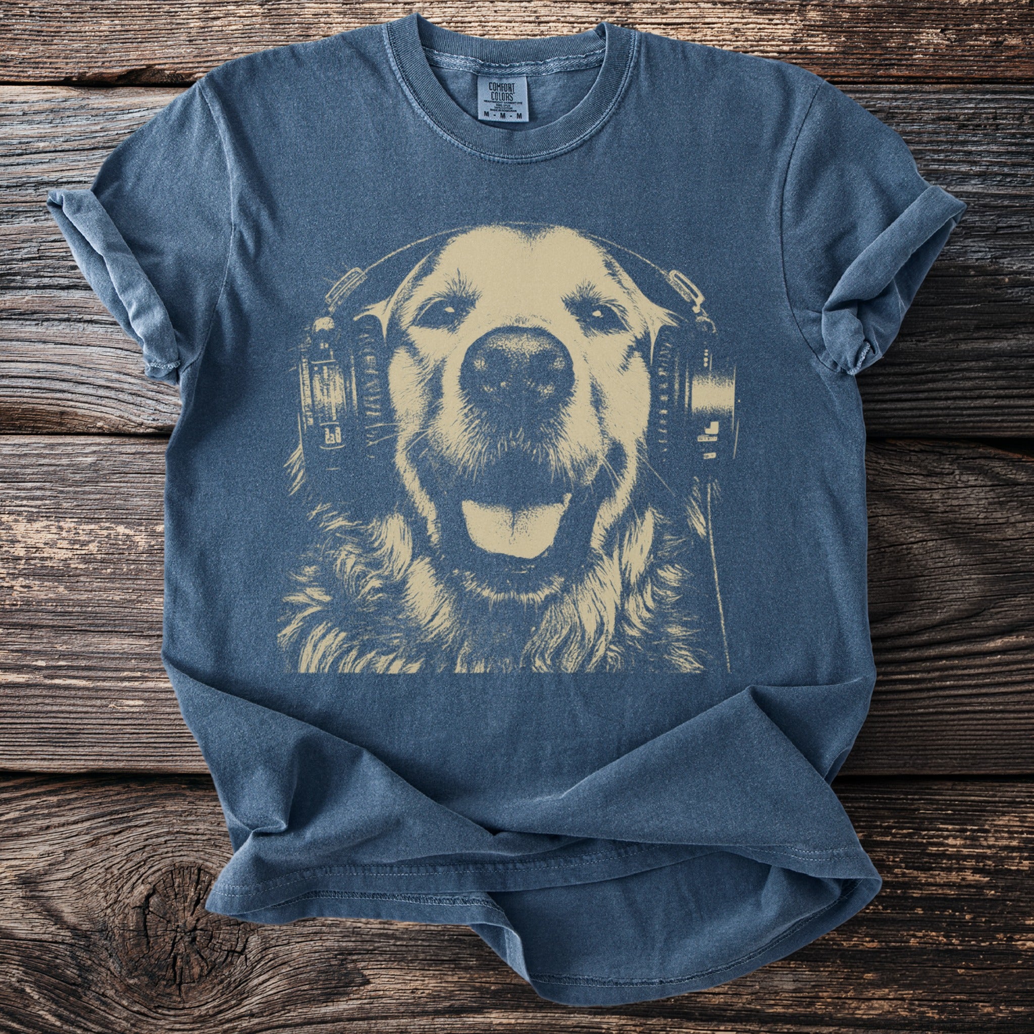 Blue t-shirt with tan graphic of a golden retriever wearing headphones.