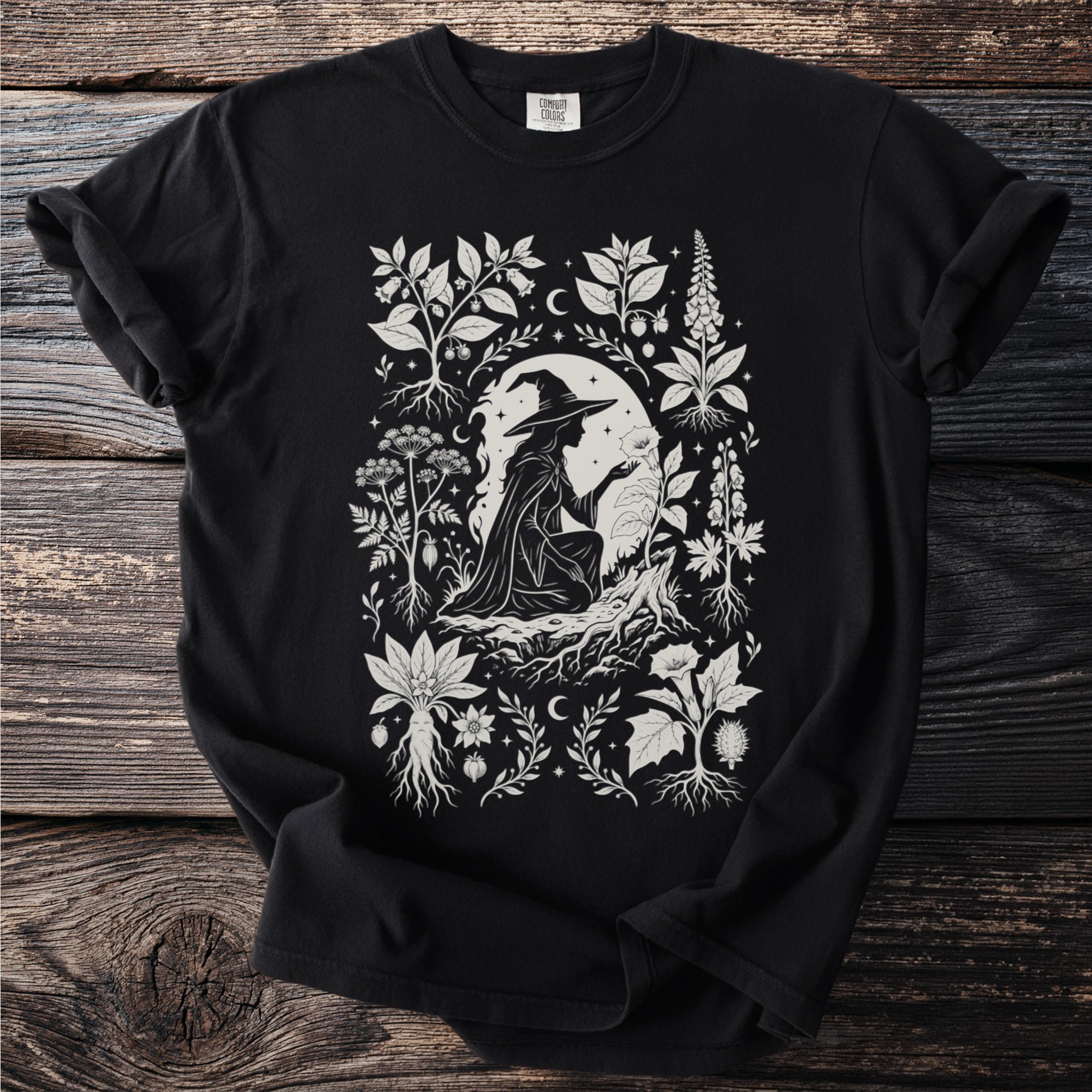 Black t-shirt with white witch and botanical illustration in medieval style.