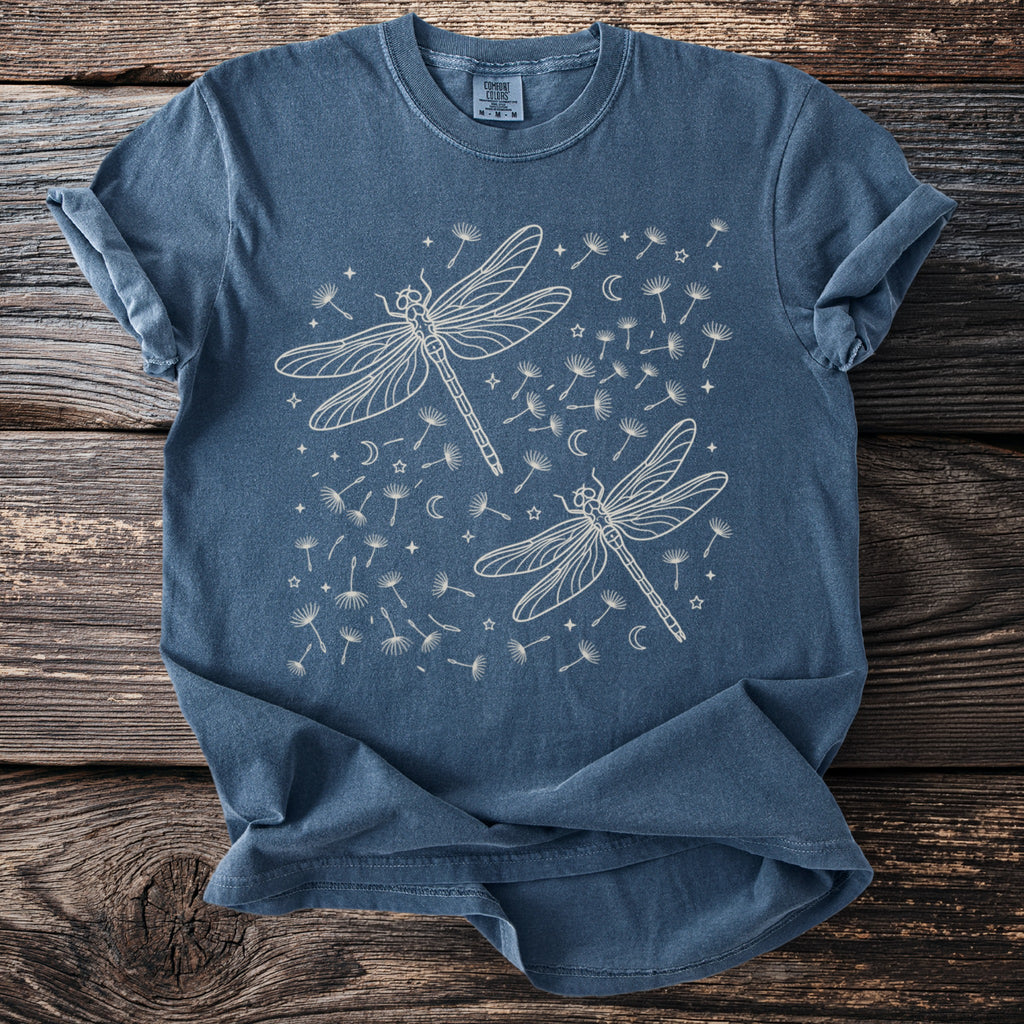 Blue t-shirt with cream line art of two dragonflies and scattered dandelions.