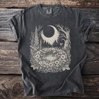 Dark t-shirt with a whimsical forest, moon, and mushroom design.