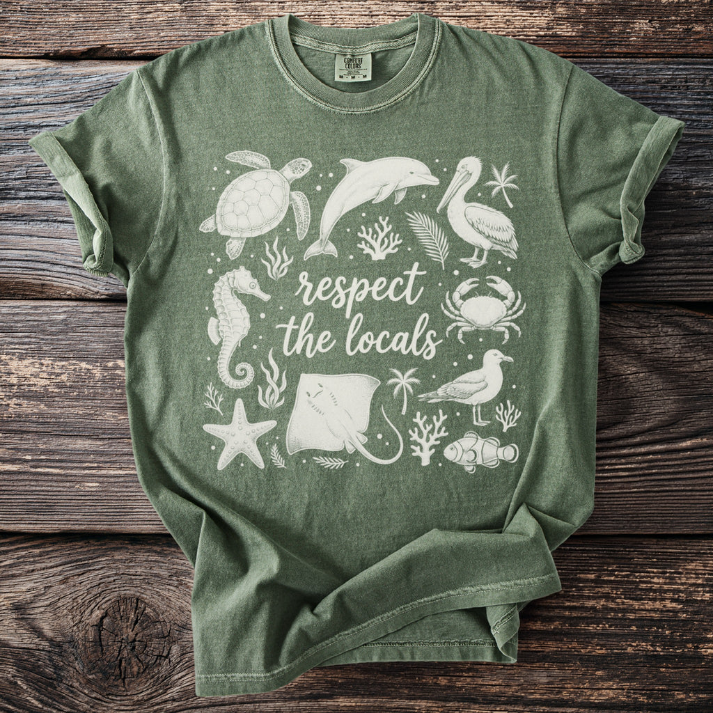Green t-shirt with white graphic of marine animals and "respect the locals" text.