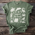 Green t-shirt with white graphic of marine animals and "respect the locals" text.