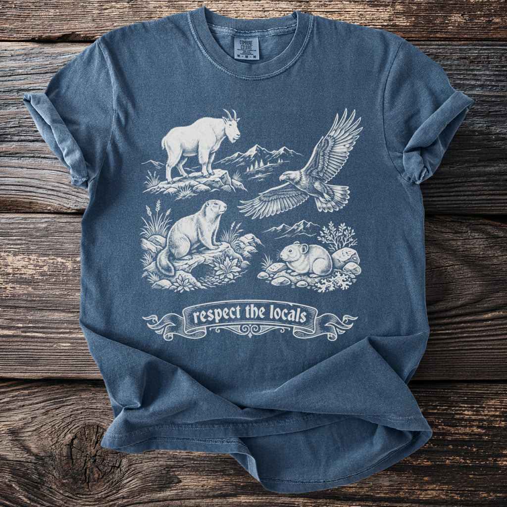 Comfort Colors t-shirt featuring a mountain goat, eagle, marmot, and pika with "respect the locals" banner.