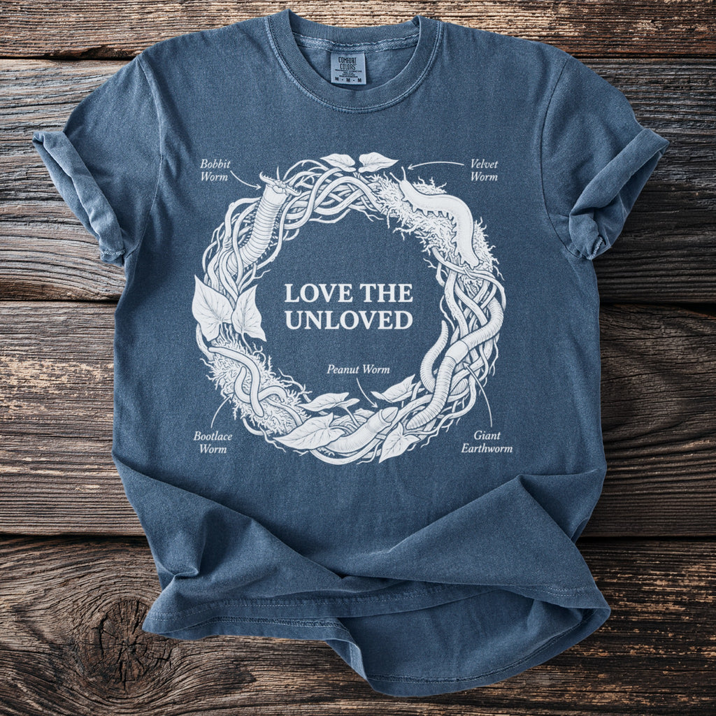 Blue t-shirt with white graphic of worms forming a circle with the text "LOVE THE UNLOVED."