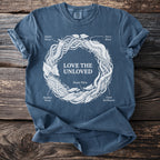 Blue t-shirt with white graphic of worms forming a circle with the text "LOVE THE UNLOVED."