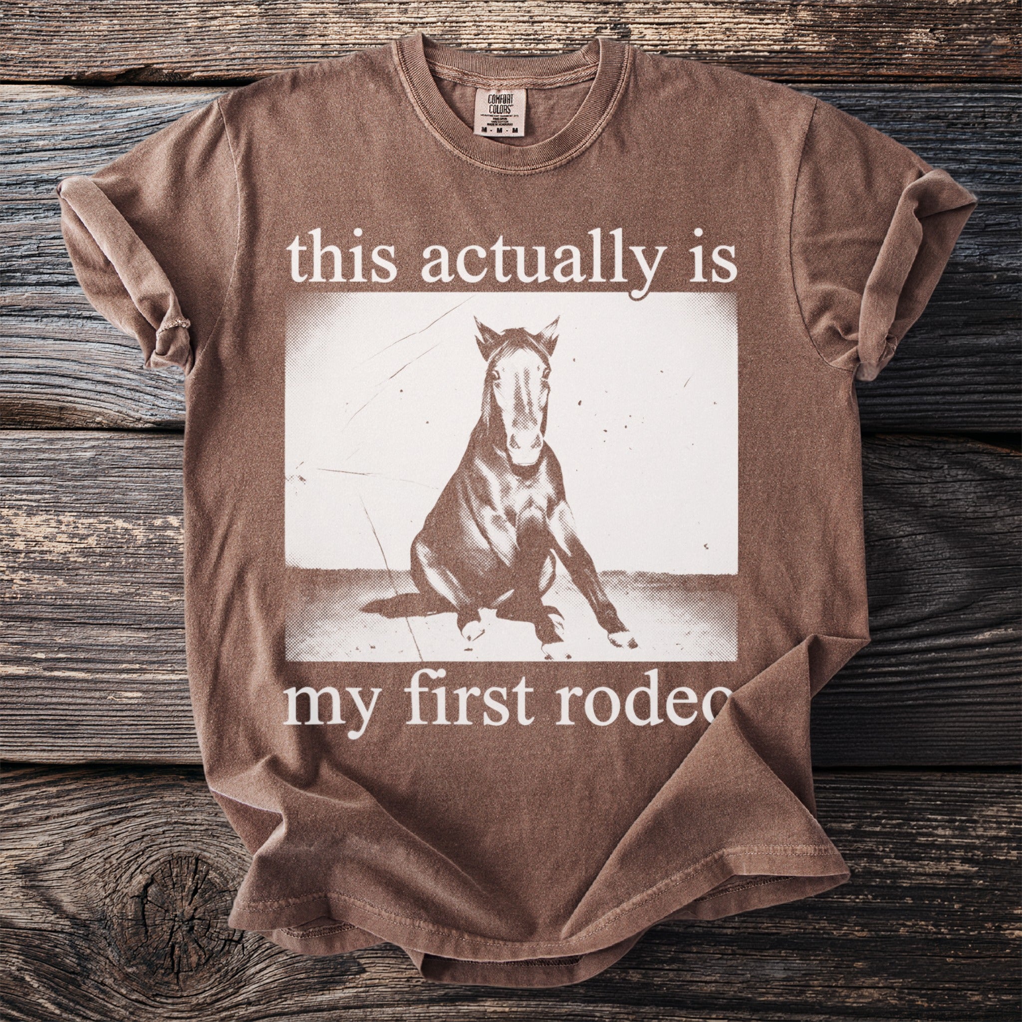 Brown t-shirt with "this actually is my first rodeo" and horse graphic.