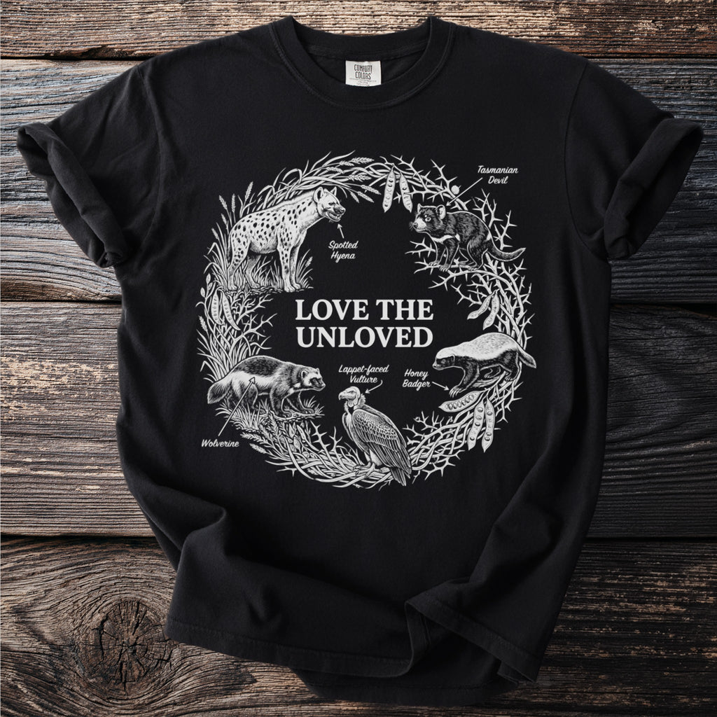 Black t-shirt with "Love the Unloved" text and illustrations of unusual animals.