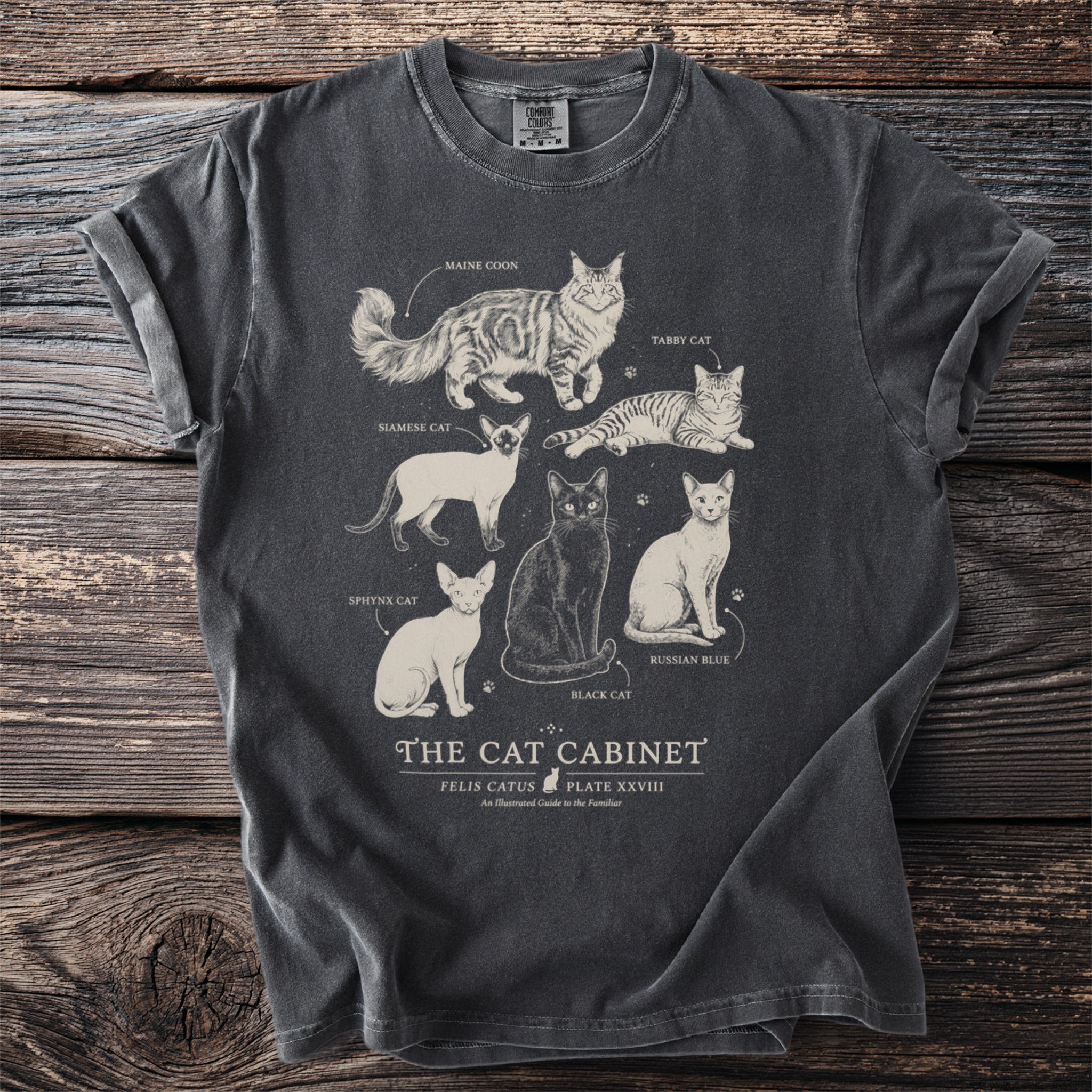T-shirt printed with an illustration of six cat breeds, "The Cat Cabinet."