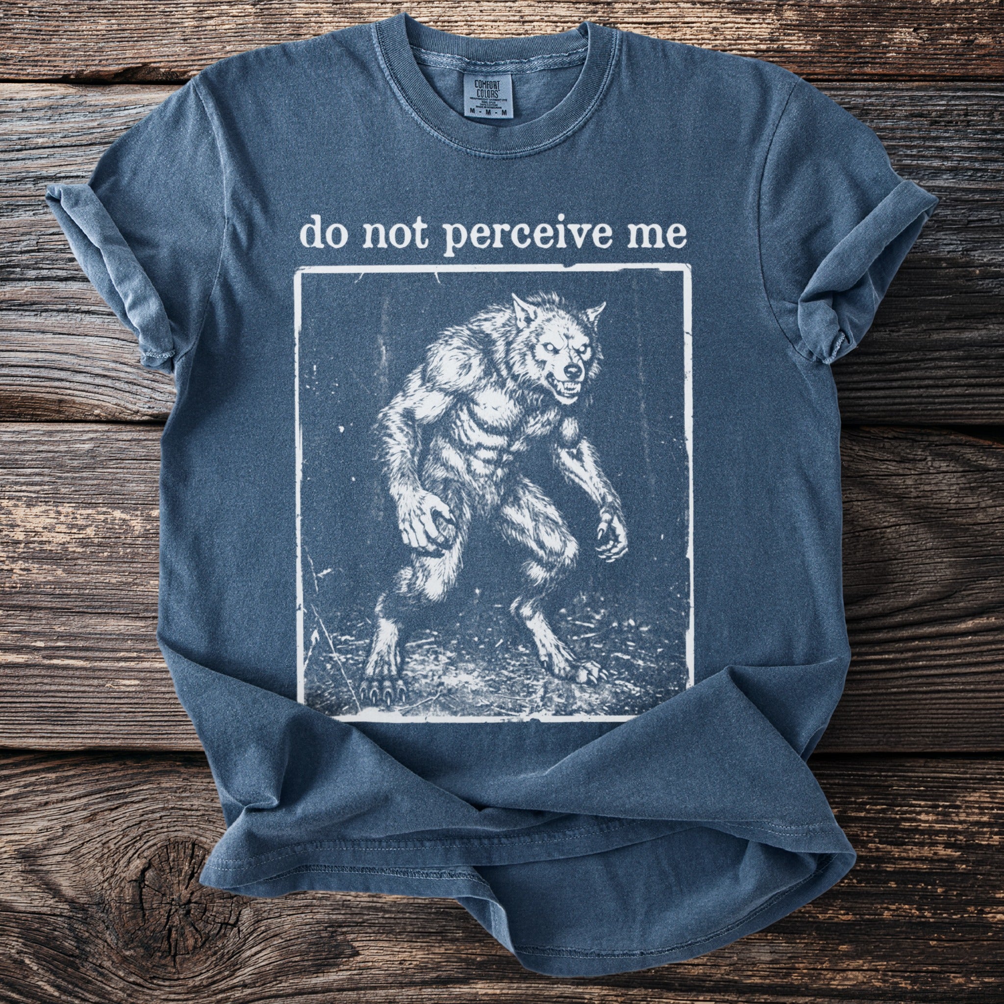 Blue t-shirt with text "do not perceive me" and a werewolf graphic.