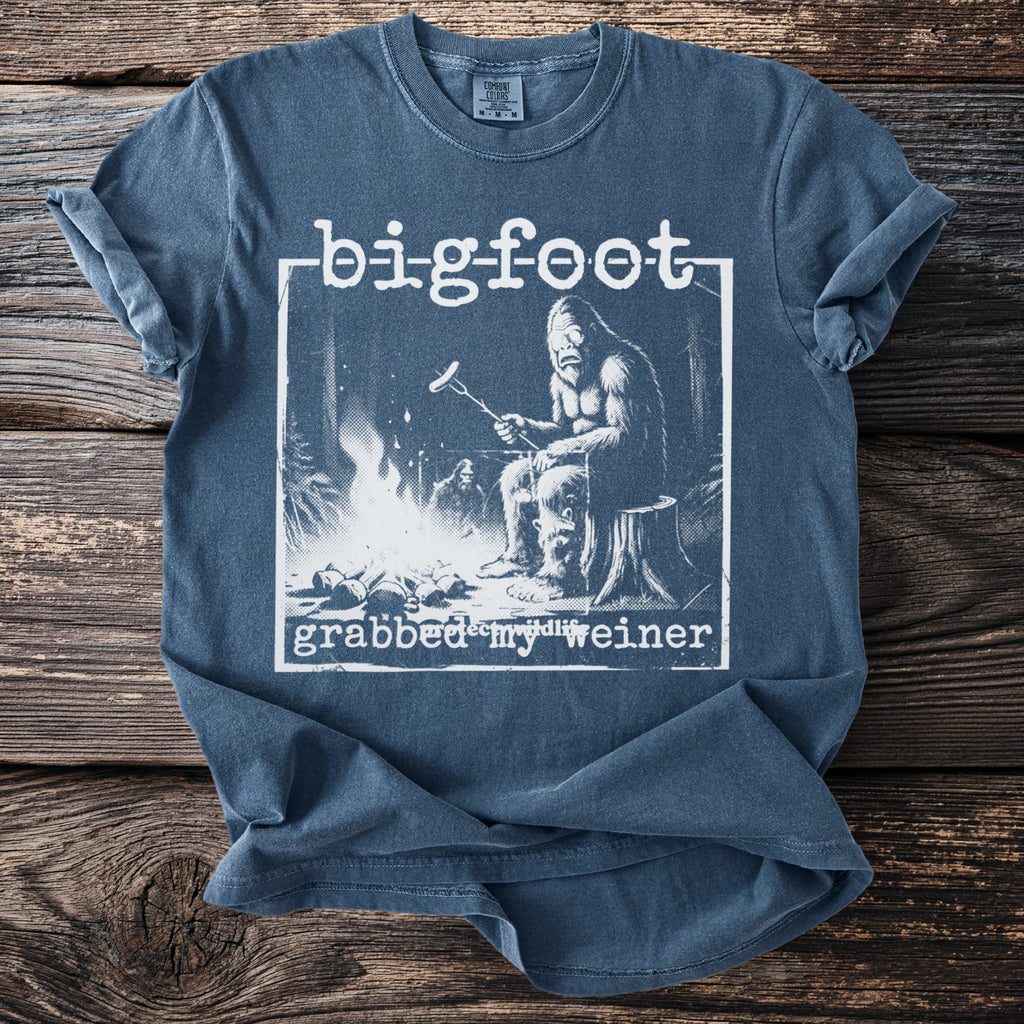 Bigfoot grilling a hot dog by a campfire with text "grabbed my weiner".
