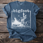 Bigfoot grilling a hot dog by a campfire with text "grabbed my weiner".