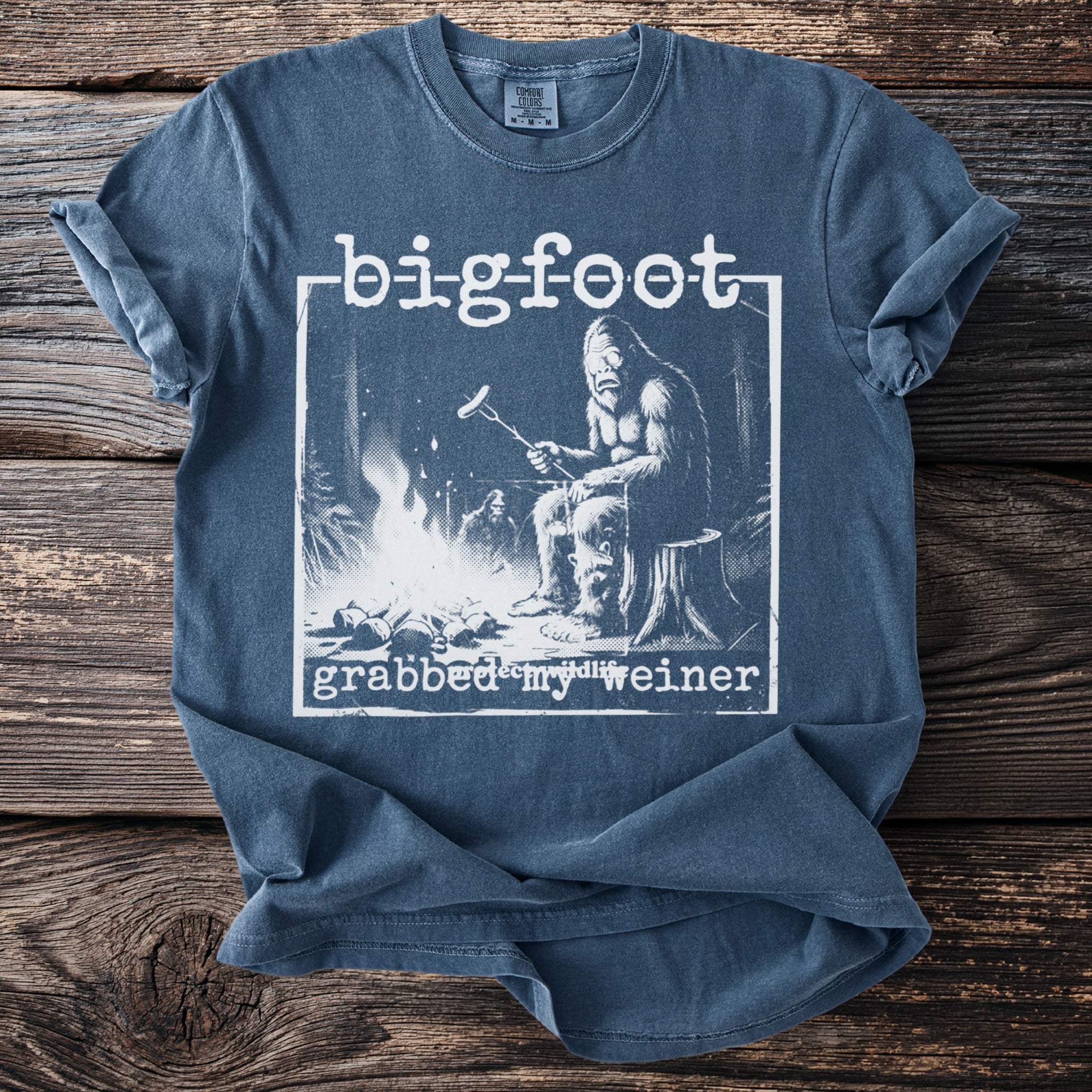 Bigfoot grilling a hot dog by a campfire with text "grabbed my weiner".