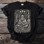 T-shirt graphic of a bearded man with a wolf and raven in a forest scene.