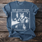 Blue t-shirt with white text "not your type" and a drawing of a muscular werewolf by a coffee cup.