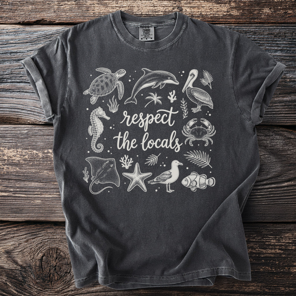 Dark grey t-shirt with white line-art of sea creatures and text "respect the locals."