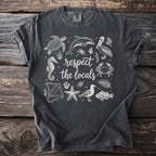 Dark grey t-shirt with white line-art of sea creatures and text "respect the locals."